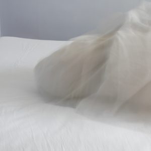 woman under bed covers