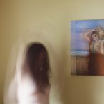 woman looking at picture on wall
