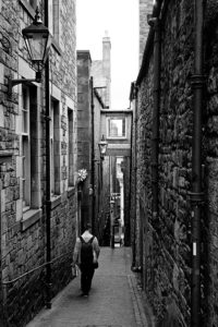Man walking through alley