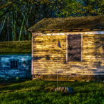 Worn yellow building with American flag